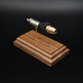 High angled front view of a .45 Auto Federal 230gr HST JHP cartridge anatomy display highlighting the projectile, simulated powder, cartridge case, primer cup, and anvil on a walnut wood base.