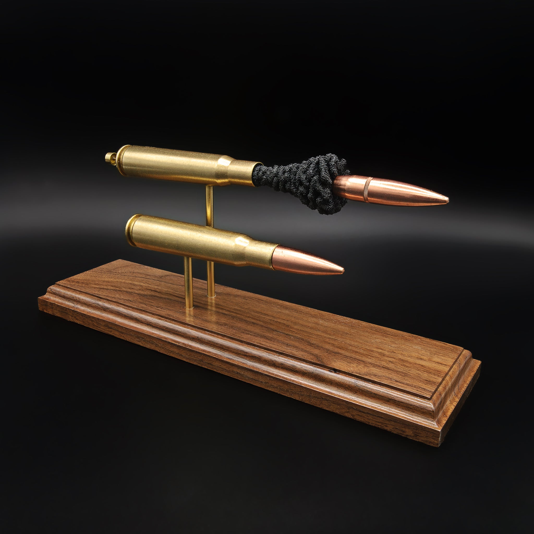 .50 BMG comparison display showing complete cartridge and exploded anatomy model on a walnut base