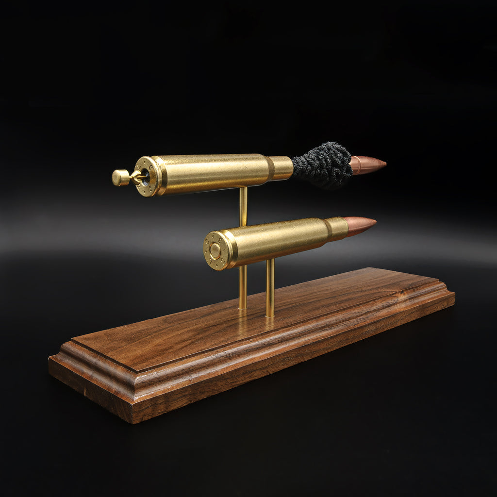 Rear angled view of .50 BMG comparison model showing cartridge bases and primer details on walnut base