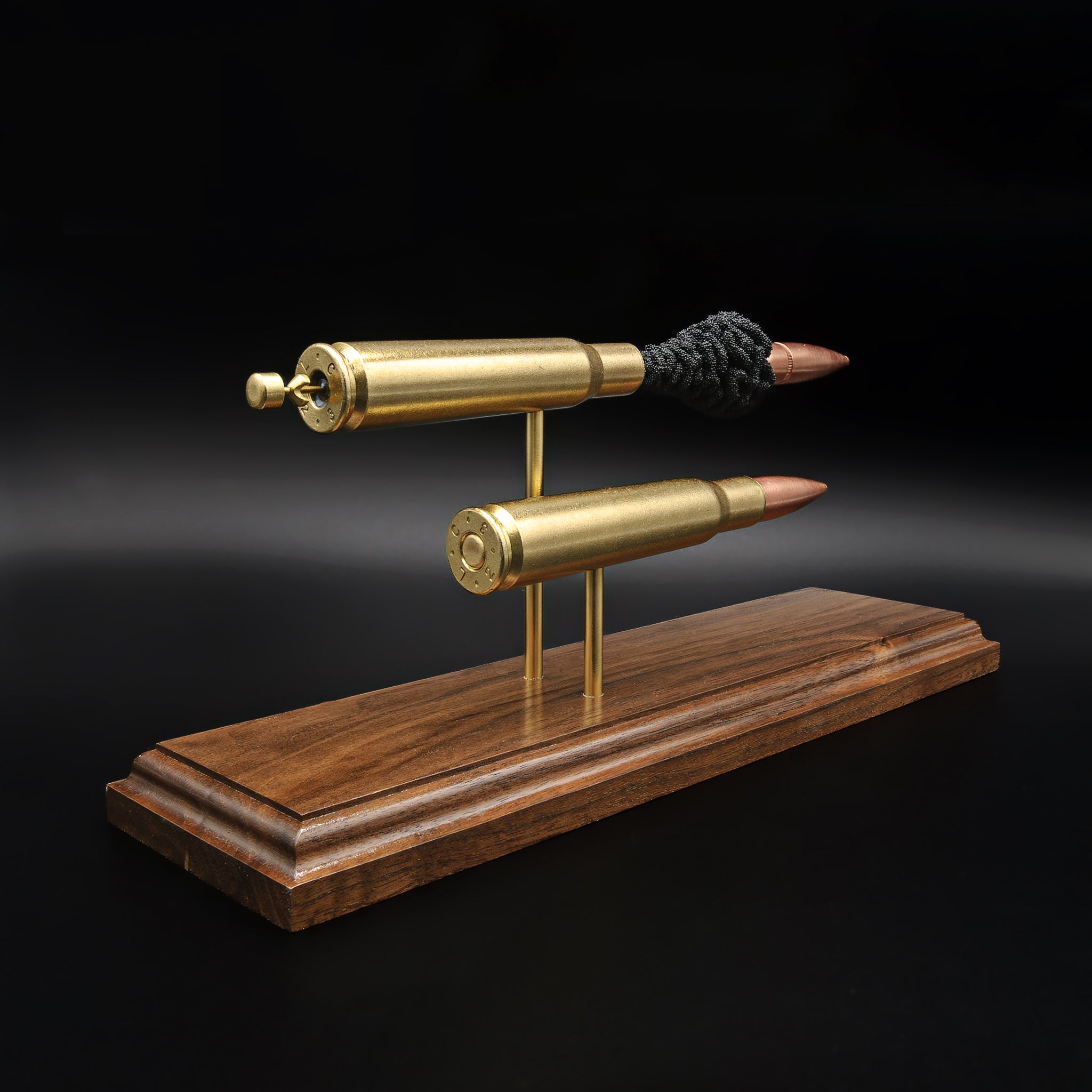 Rear angled view of .50 BMG comparison model showing cartridge bases and primer details on walnut base