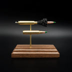 Front view of a 5.56x45 NATO SS109 Green Tip Comparison Series display featuring an exploded cartridge with exposed simulated powder displayed above a complete live cartridge on a handcrafted walnut wood base.