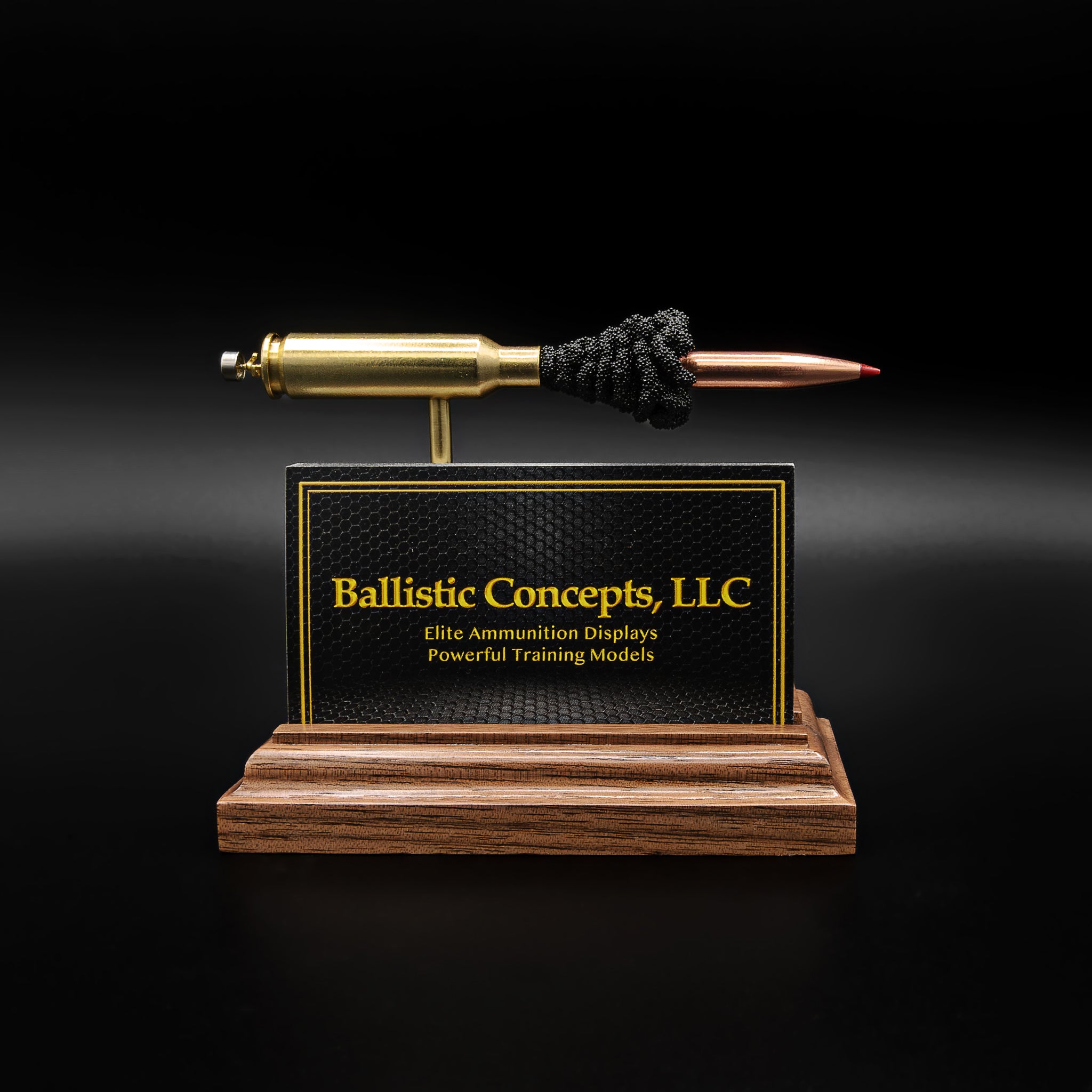 Handmade ammunition display stand holding business cards, featuring real brass and bullet components on solid wood base