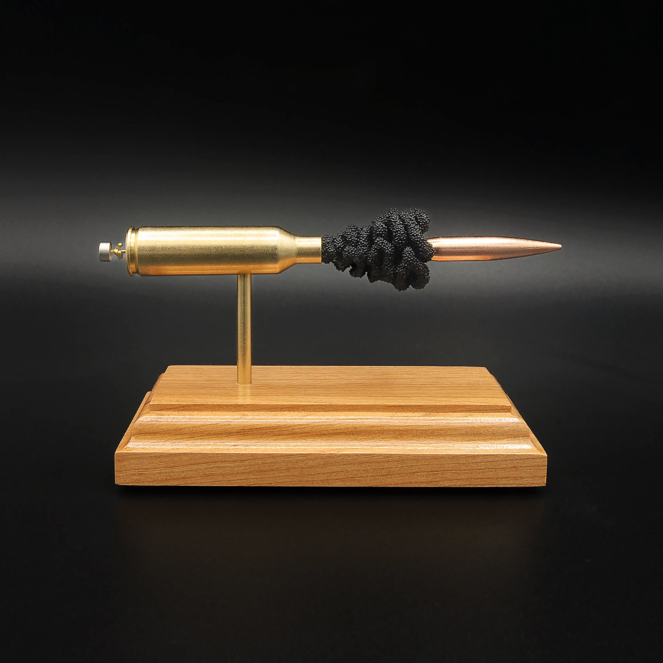 Front view of a 6.5 PRC Berger 153.5gr Long Range Hybrid Target cartridge anatomy display showing the primer cup, anvil, Lapua cartridge case, simulated powder, and projectile on a hardwood base.