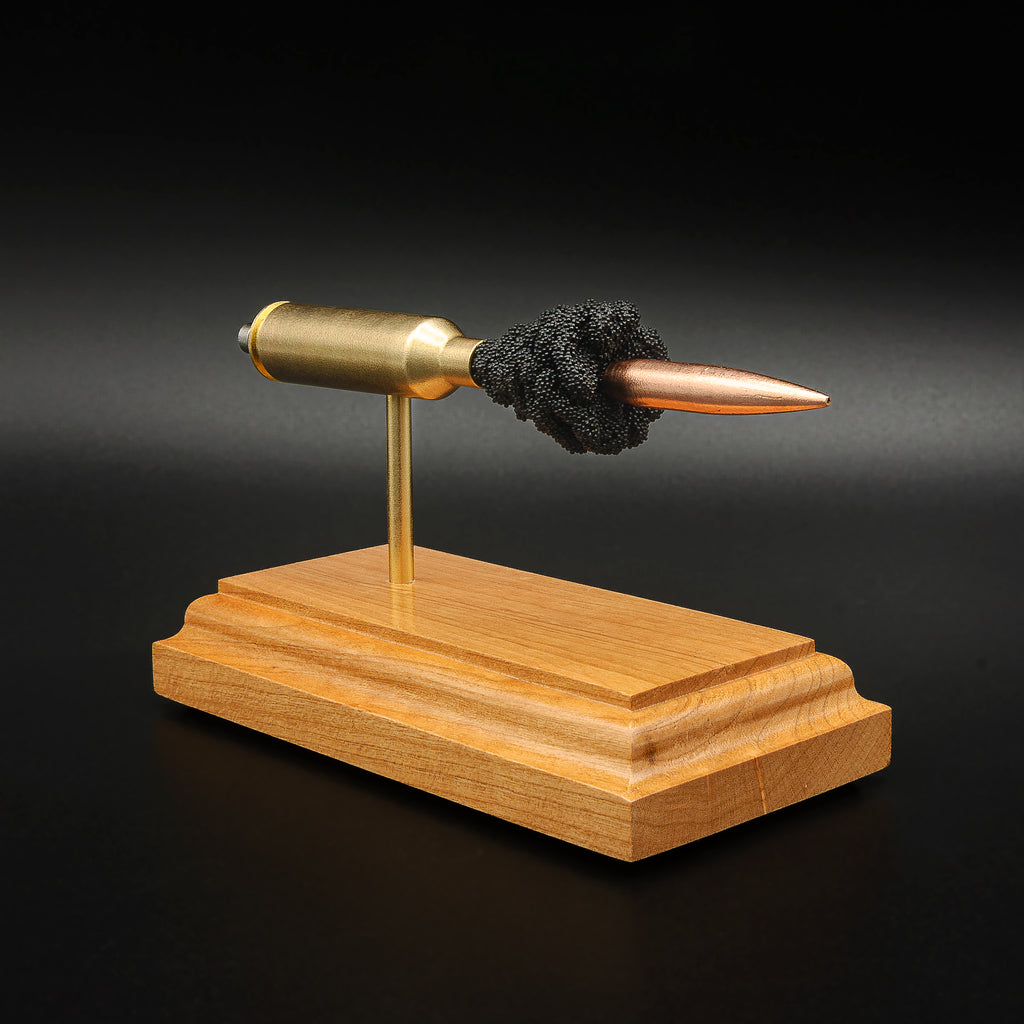 Angled view of a 6.5 PRC Berger 153.5gr LRHT cartridge anatomy display with the primer cup, anvil, Lapua brass cartridge case, simulated powder, and projectile visible.
