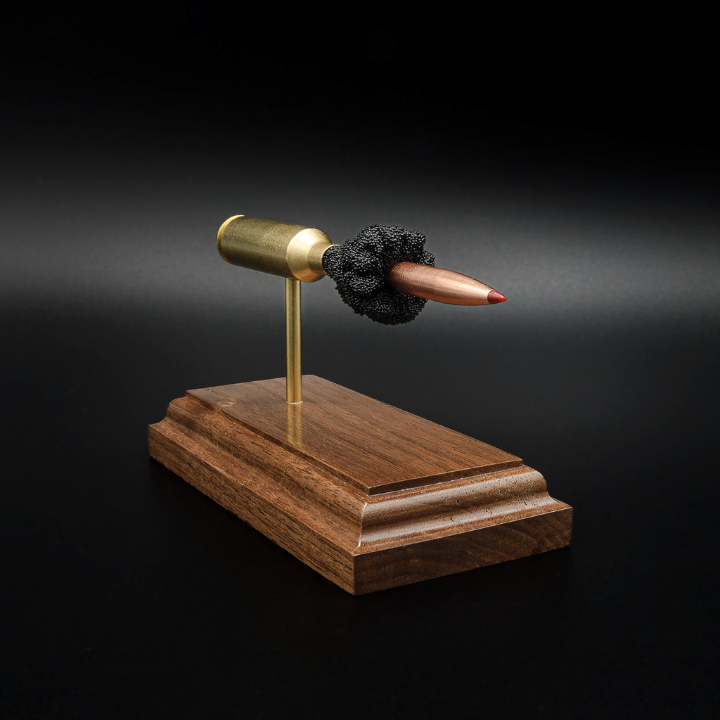 Front-left angle of a 6.5 PRC anatomy cartridge display showcasing the Hornady 147gr ELD-M Match bullet and handcrafted walnut display base.