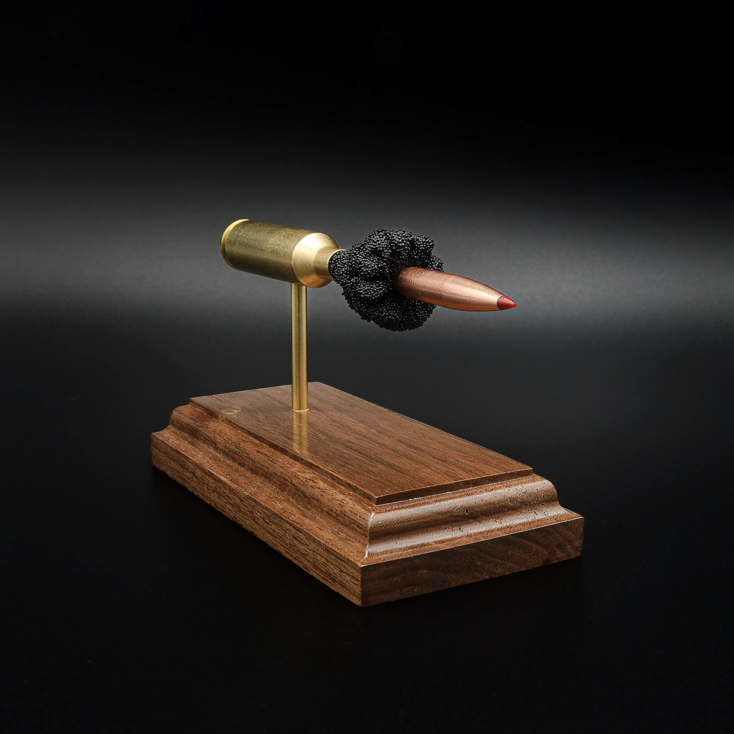 Front-left angle of a 6.5 PRC anatomy cartridge display showcasing the Hornady 147gr ELD-M Match bullet and handcrafted walnut display base.