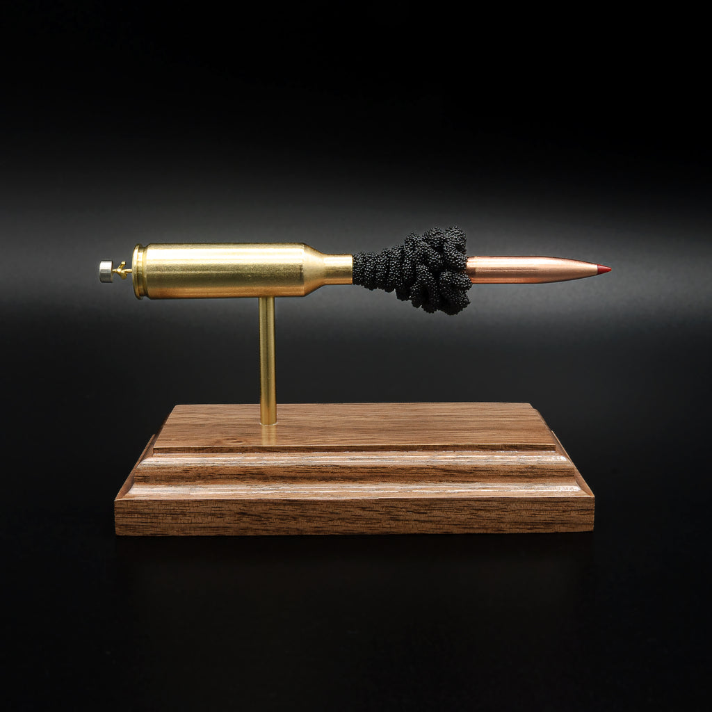 Full side profile of an inert 6.5 PRC exploded ammunition display with a Hornady 147gr ELD-M Match bullet, exposed simulated powder, and walnut base.