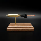 Full side profile of an inert 6.5 PRC exploded ammunition display with a Hornady 147gr ELD-M Match bullet, exposed simulated powder, and walnut base.