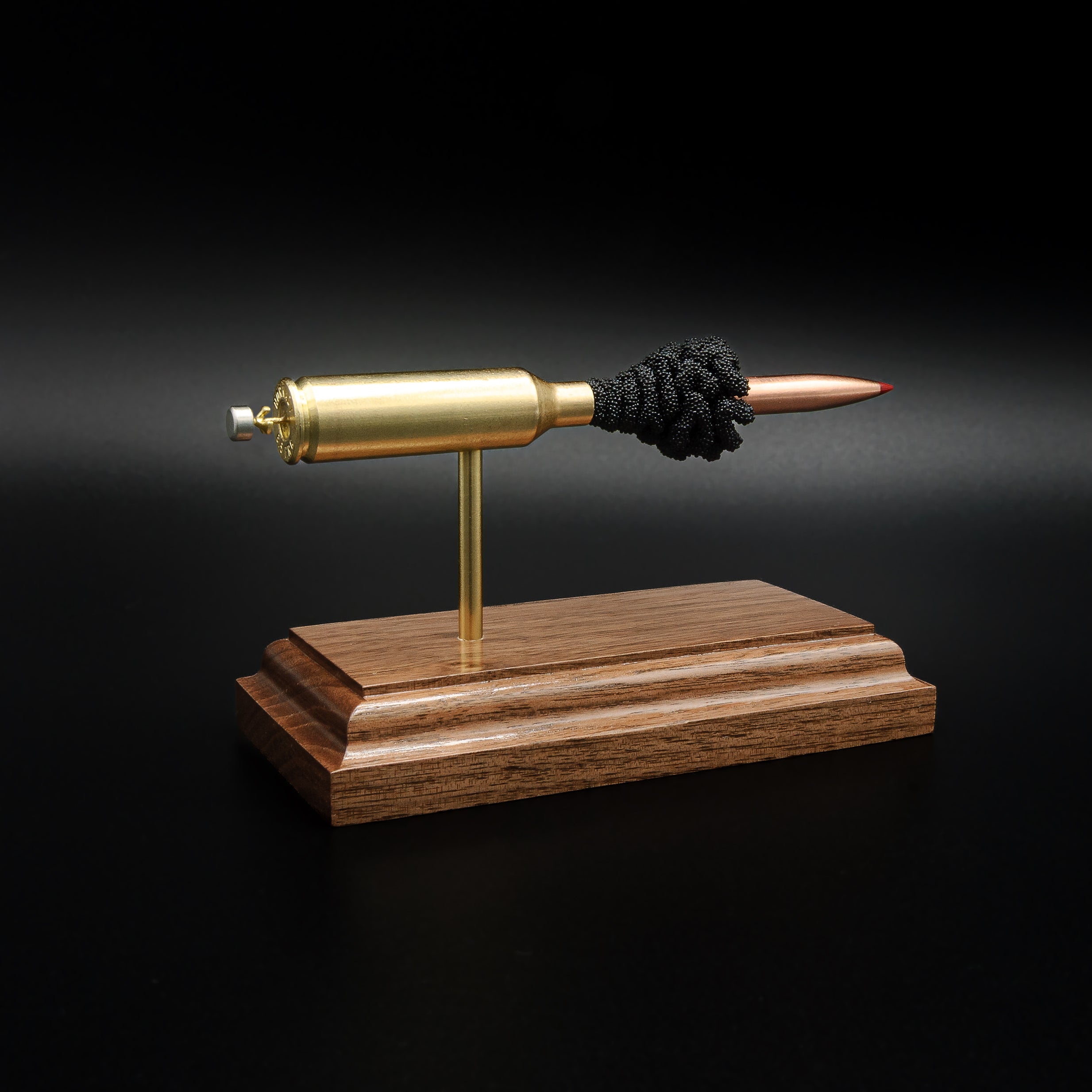 Rear three-quarter view of a handcrafted 6.5 PRC cartridge display highlighting the brass case, Hornady 147gr ELD-M Match bullet, and walnut wood base.