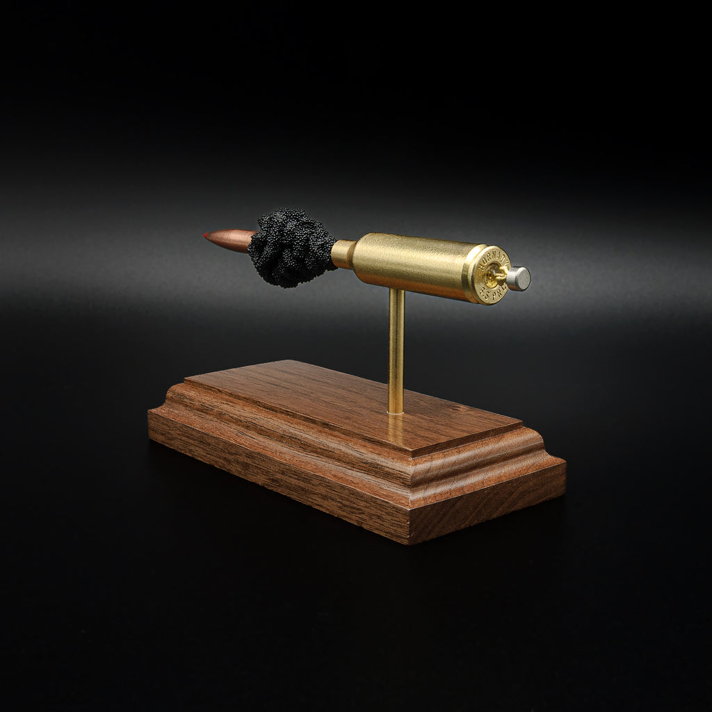 Opposite rear angle of a 6.5 PRC anatomy cartridge display featuring the Hornady 147gr ELD-M Match projectile, exposed powder column, and walnut wood base.