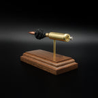 Opposite rear angle of a 6.5 PRC anatomy cartridge display featuring the Hornady 147gr ELD-M Match projectile, exposed powder column, and walnut wood base.