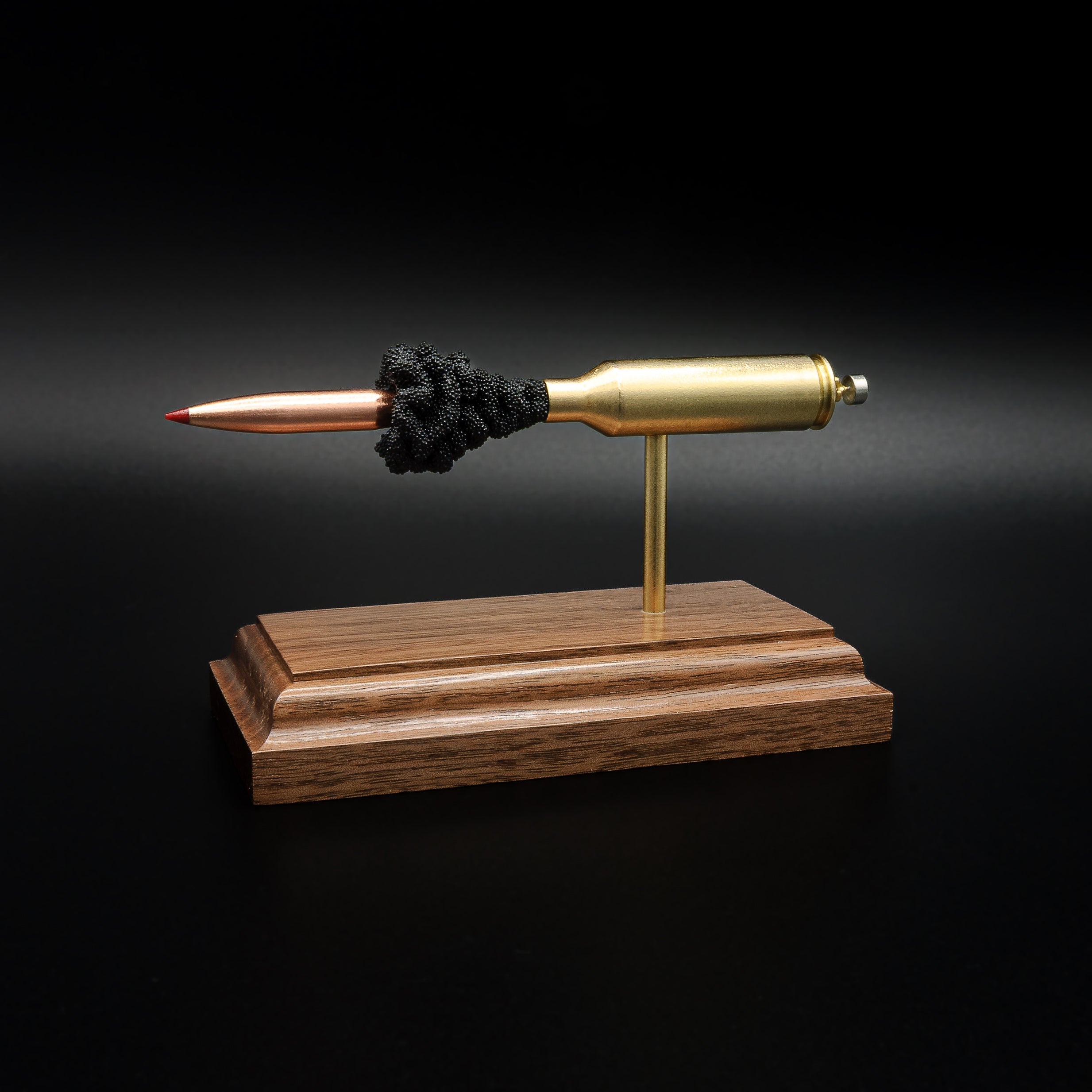 Opposite side profile of an inert 6.5 PRC exploded cartridge display with a Hornady 147gr ELD-M Match bullet, simulated powder, and handcrafted walnut base.