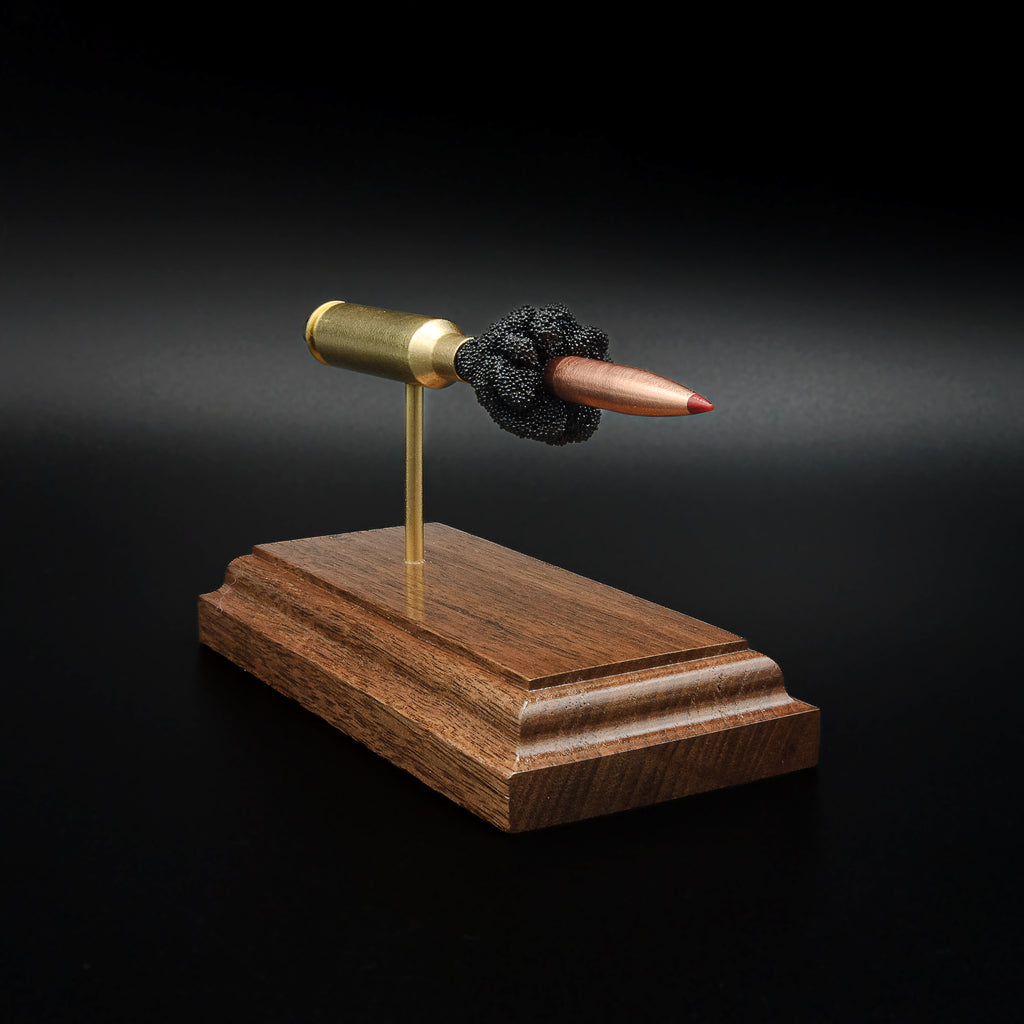 Right-front angle of an inert 6.5 Creedmoor exploded ammunition display showing the Hornady 143gr ELD-X projectile, brass case, and exposed simulated powder.