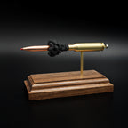 Opposite side profile of an inert 6.5 Creedmoor exploded cartridge display featuring a Hornady 143gr ELD-X bullet, simulated powder, and walnut wood base.