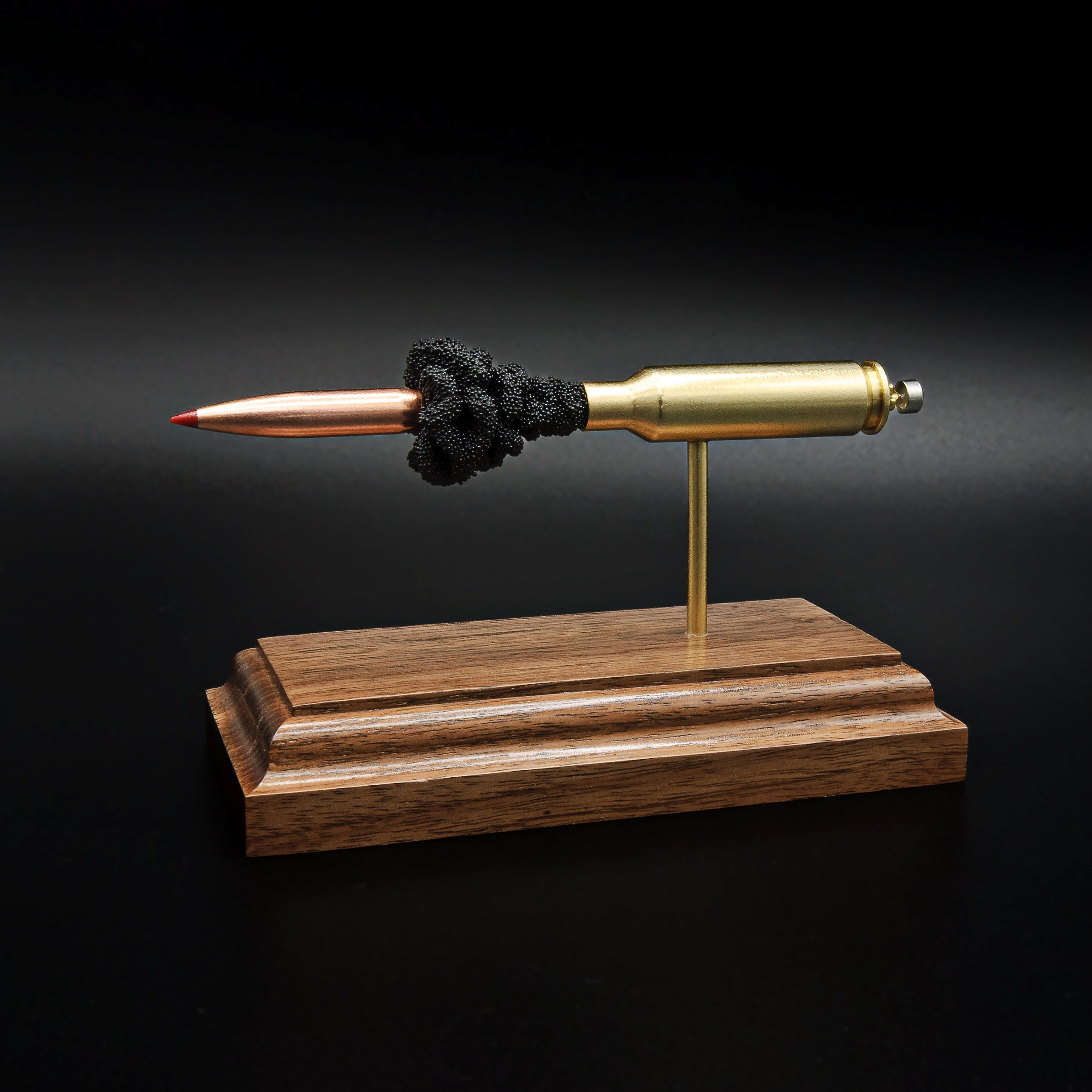 Opposite side profile of an inert 6.5 Creedmoor exploded cartridge display featuring a Hornady 143gr ELD-X bullet, simulated powder, and walnut wood base.