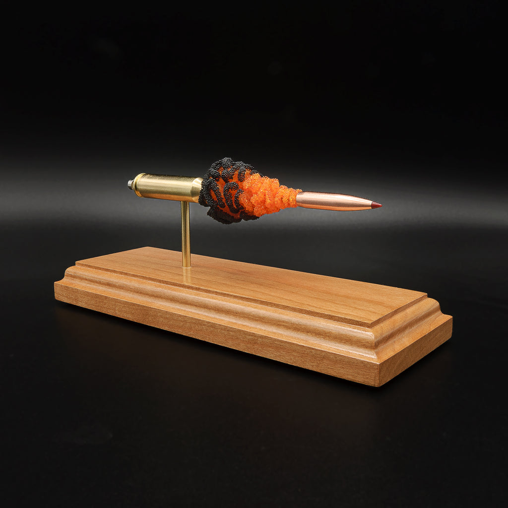Angled 6.5 Creedmoor FirePowder display showing the Hornady 143gr ELD-X projectile, orange and black simulated powder, Alpha brass case, primer cup, and anvil.