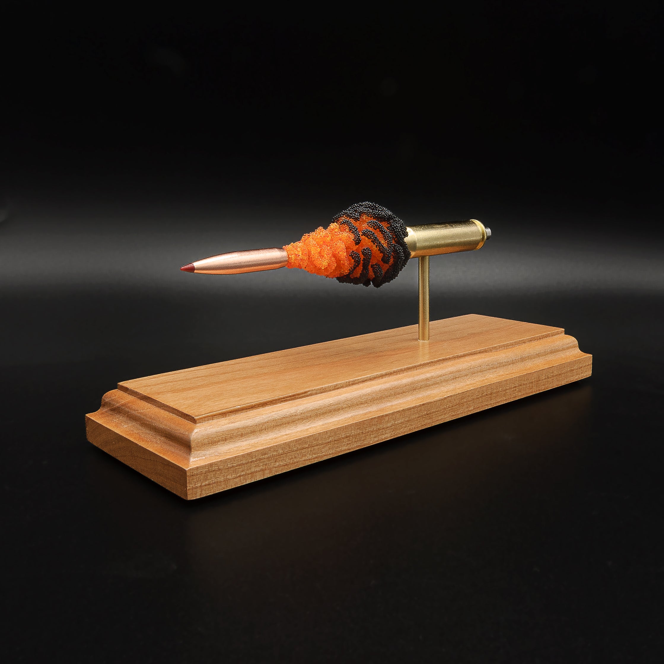 Opposite side view of a 6.5 Creedmoor FirePowder cartridge display with Hornady 143gr ELD-X, Alpha Munitions case, simulated powder, primer cup, and anvil on cherry.