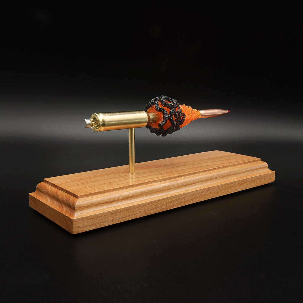 Angled 6.5 Creedmoor FirePowder display featuring Alpha Munitions novelty brass, Hornady 143gr ELD-X projectile, primer cup, anvil, and orange and black simulated powder.