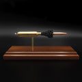 7mm PRC Hornady 180gr ELD-M expanded cartridge display on Bolivian Rosewood base showing visible primer cup, anvil, cartridge case, simulated powder, and projectile in left side profile.