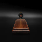 Front view of a 7mm PRC Hornady 180gr ELD-M expanded cartridge display on a Bolivian Rosewood base with visible primer cup, anvil, cartridge case, simulated powder, and projectile.