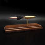 Right side profile of a 7mm PRC Hornady 180gr ELD-M expanded cartridge display mounted on a Bolivian Rosewood base with visible primer cup, anvil, cartridge case, simulated powder, and projectile.