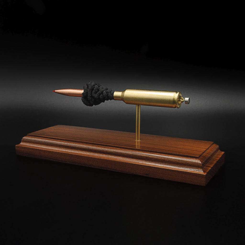 Rear angled view of a 7mm PRC Hornady 180gr ELD-M expanded cartridge display on a Bolivian Rosewood base featuring the primer cup, anvil, cartridge case, simulated powder, and projectile.