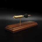 High angle front three-quarter view of a 7mm PRC Hornady 180gr ELD-M expanded cartridge display on a Bolivian Rosewood base with visible primer cup, anvil, cartridge case, simulated powder, and projectile.