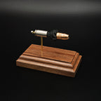Front-left three-quarter view of an exploded 9mm Luger cartridge display featuring a Federal 147 grain HST hollow point bullet with exposed simulated powder mounted on a handcrafted walnut wood presentation base.