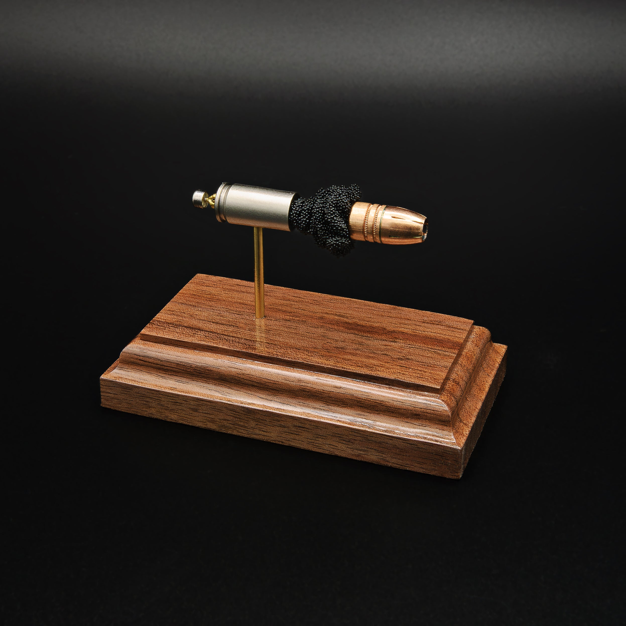 Front-left three-quarter view of an exploded 9mm Luger cartridge display featuring a Federal 147 grain HST hollow point bullet with exposed simulated powder mounted on a handcrafted walnut wood presentation base.