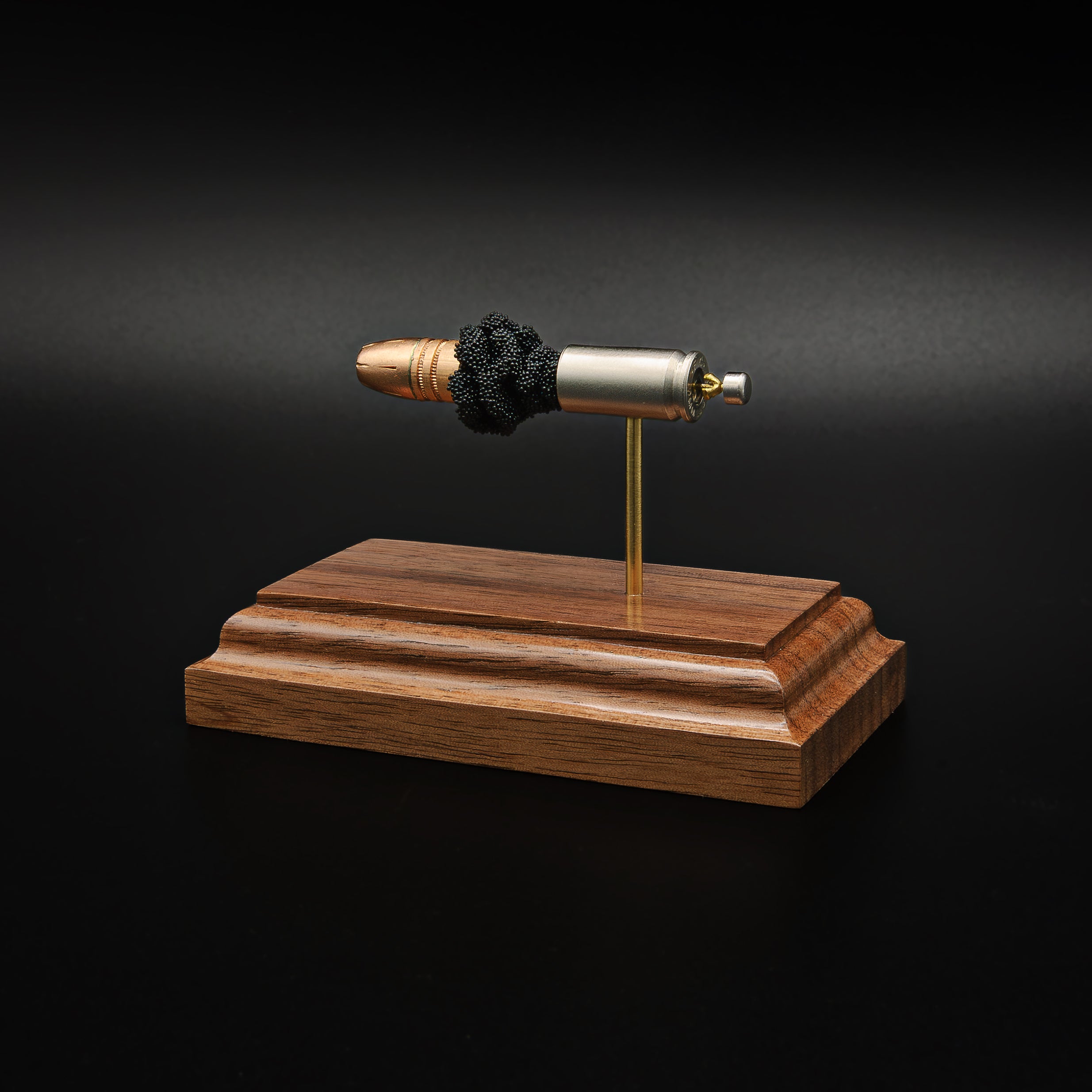 Rear-right perspective of a handcrafted 9mm Luger exploded cartridge display featuring the Federal 147gr HST hollow point projectile, nickel-plated case, exposed simulated powder, and walnut wood base.