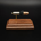 Front profile of a handcrafted 9mm Luger display showcasing the Federal 147gr HST hollow point bullet, nickel-plated case, exposed simulated powder, and walnut wood base.