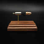 Side profile of a handcrafted 9mm Luger cartridge display with a Federal 147 grain HST hollow point bullet separated from the case by exposed simulated powder and mounted on a walnut presentation base.
