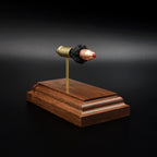 Hornady Critical Defense 115gr FTX 9mm Luger cartridge model with separated components on walnut base