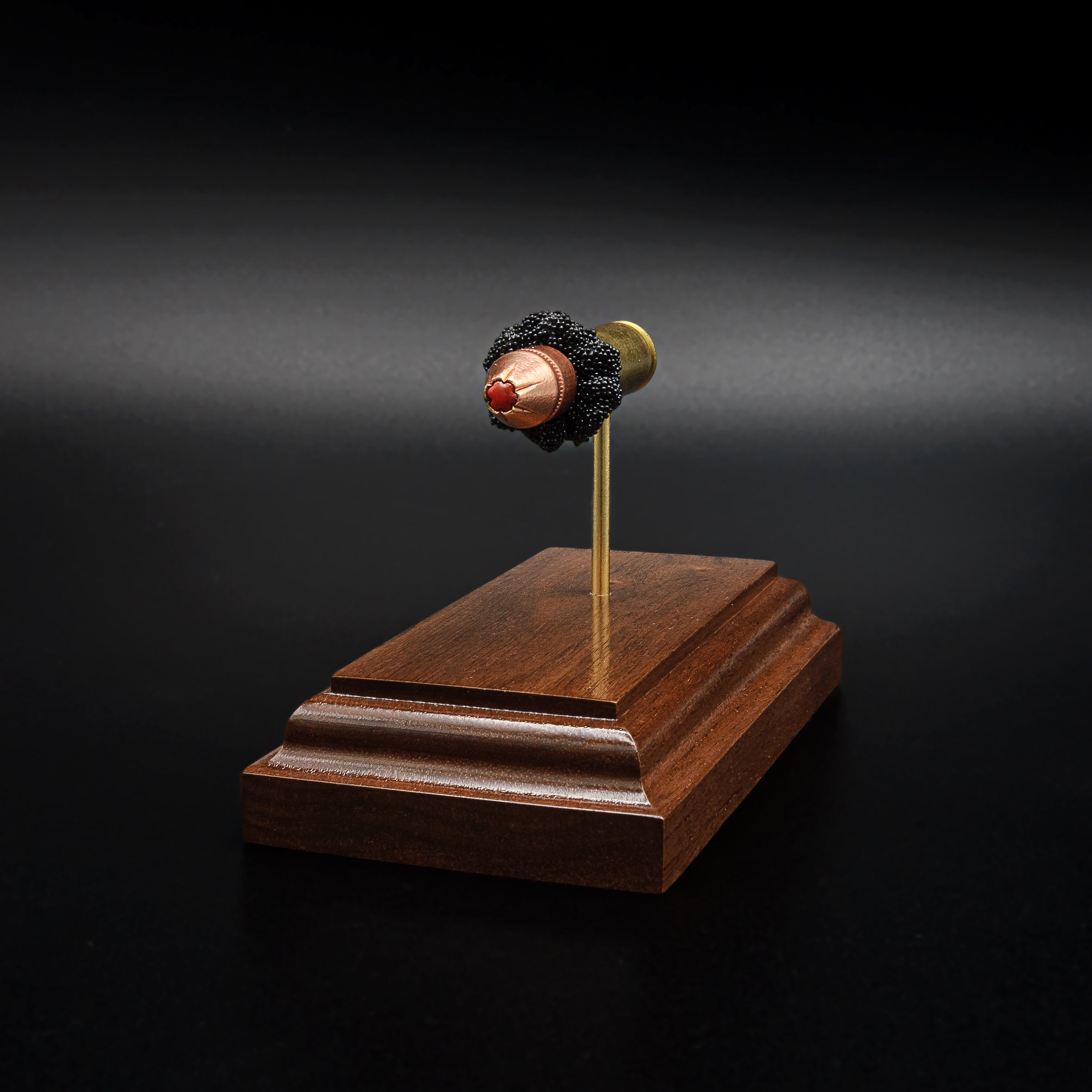 Premium walnut display featuring an exploded 9mm Luger Hornady Critical Defense 115gr FTX cartridge