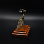 Angled view of ammunition-inspired desk accessory holding business cards, combining functional design with display appeal