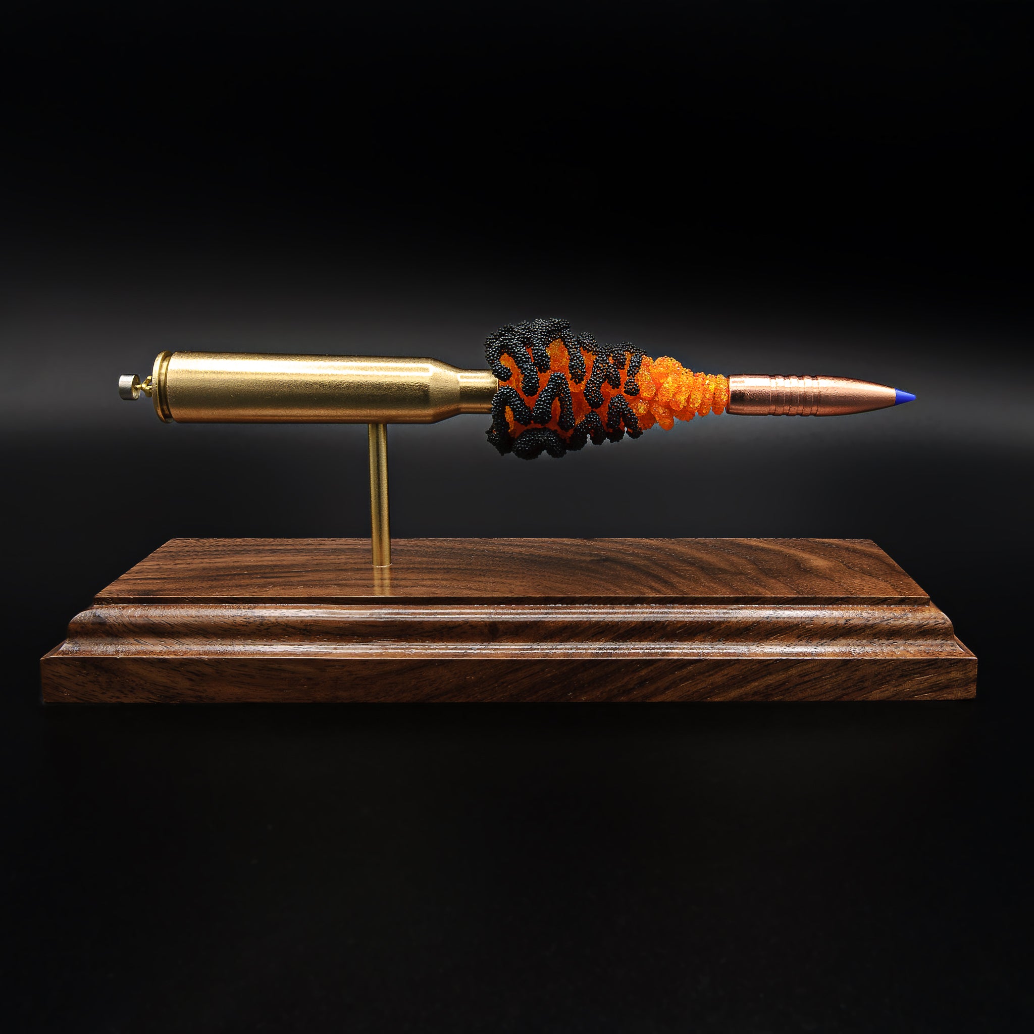 Exploded 338 Lapua Magnum cartridge display with Barnes TTSX bullet and stylized fire powder effect on walnut base, side profile