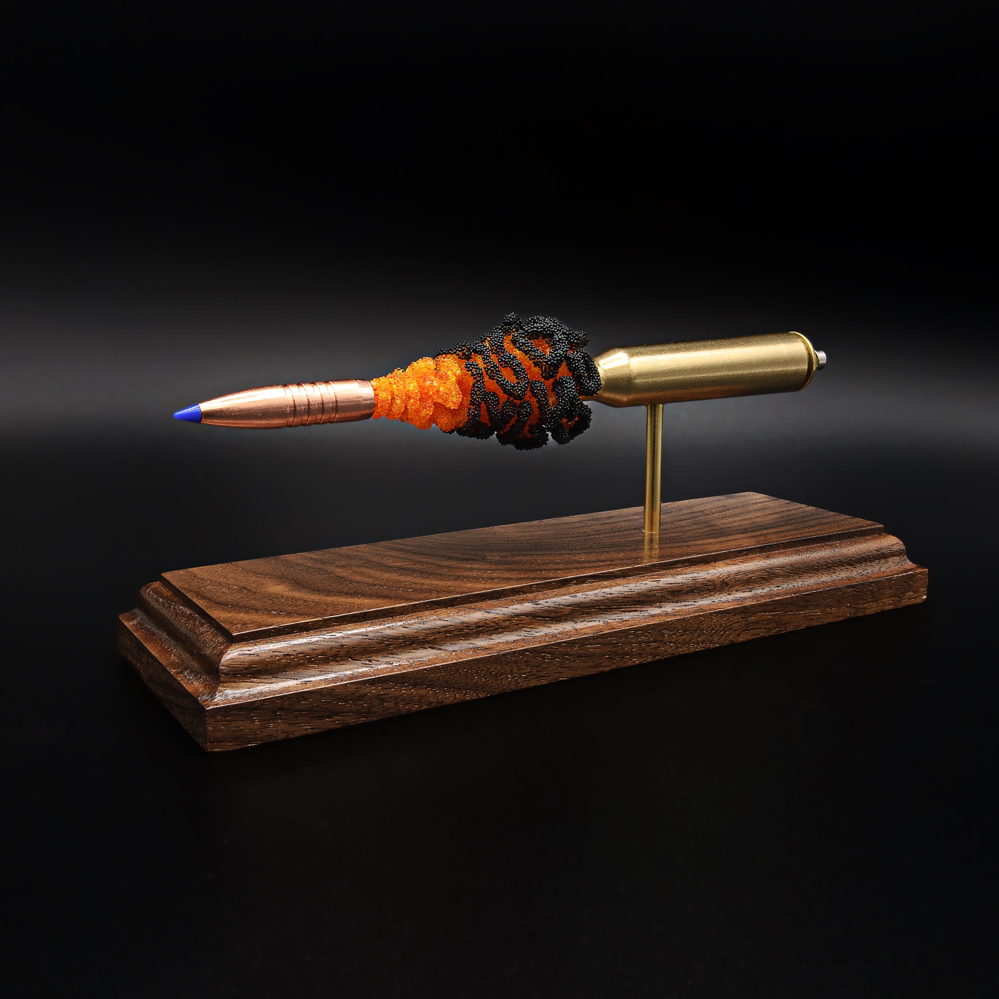 Close front angle of copper rifle bullet with blue tip and textured powder effect in 338 Lapua display model