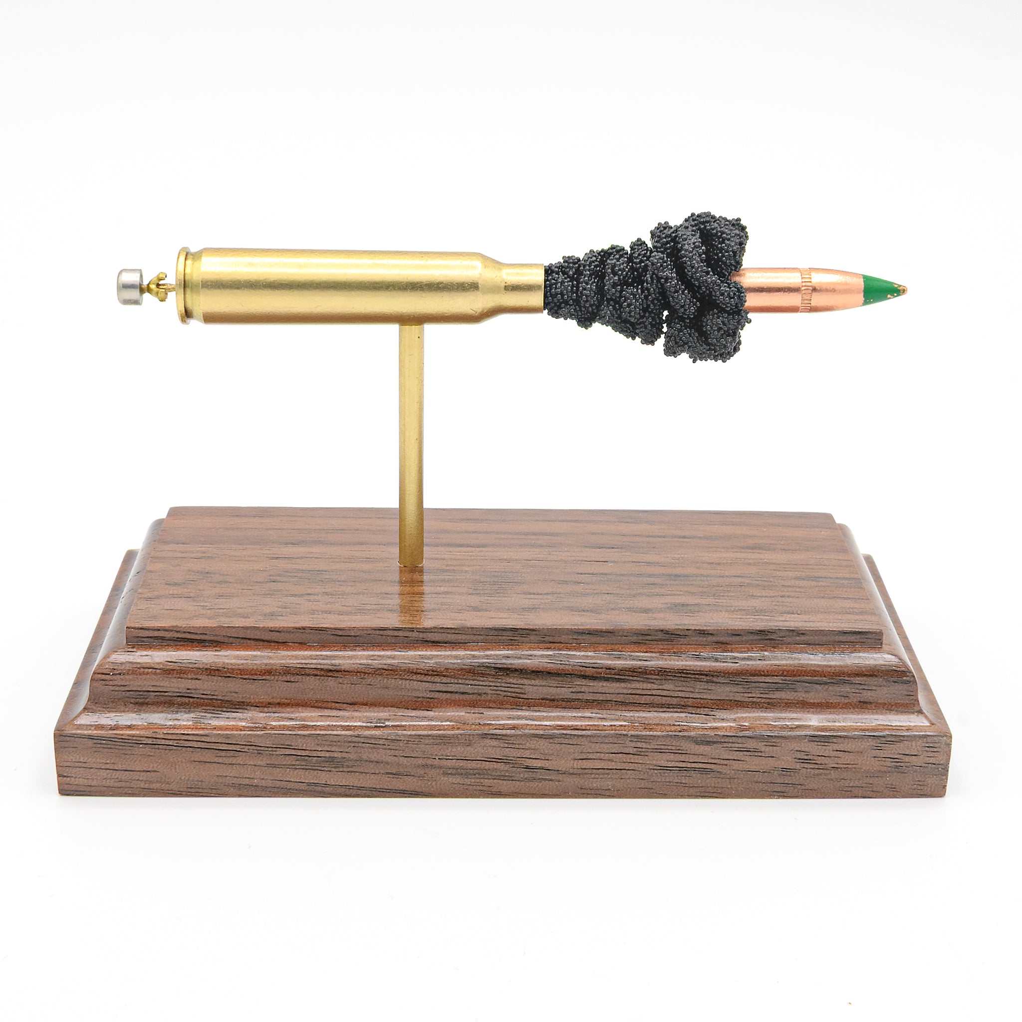 Sectioned 5.56x45mm M855 cartridge showing primer case powder and green tip SS109 bullet aligned horizontally