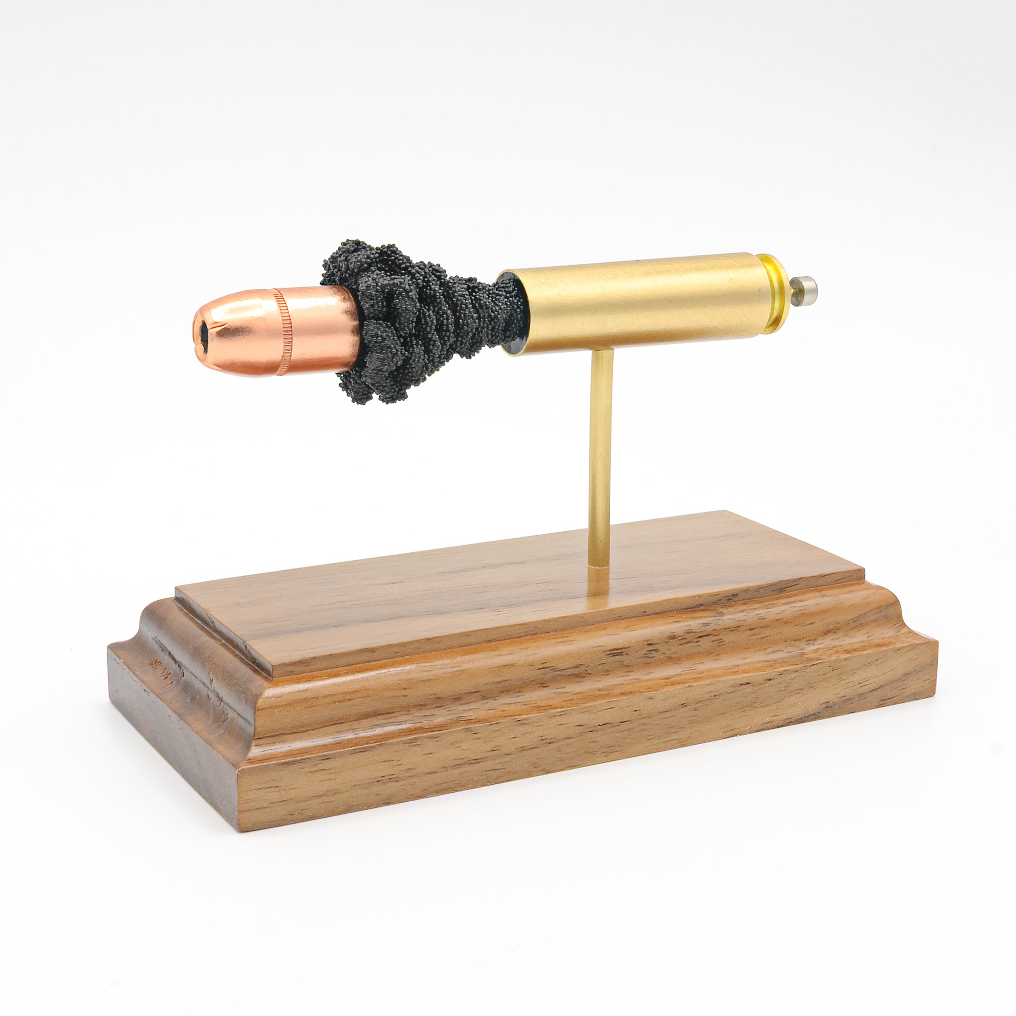 450 Bushmaster cutaway cartridge display mounted on solid hardwood base