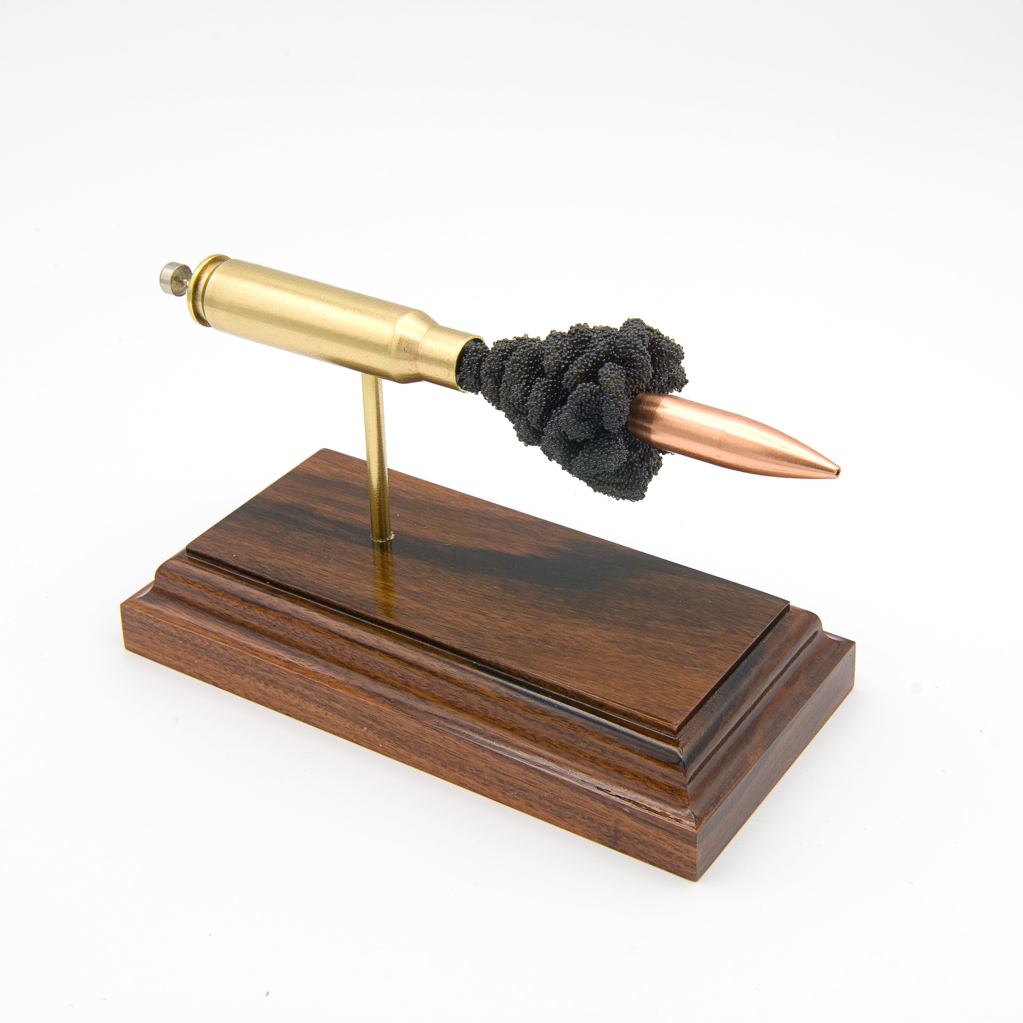 7.62x51mm M118 175gr Sierra MatchKing HPBT expanded cartridge display on hardwood base