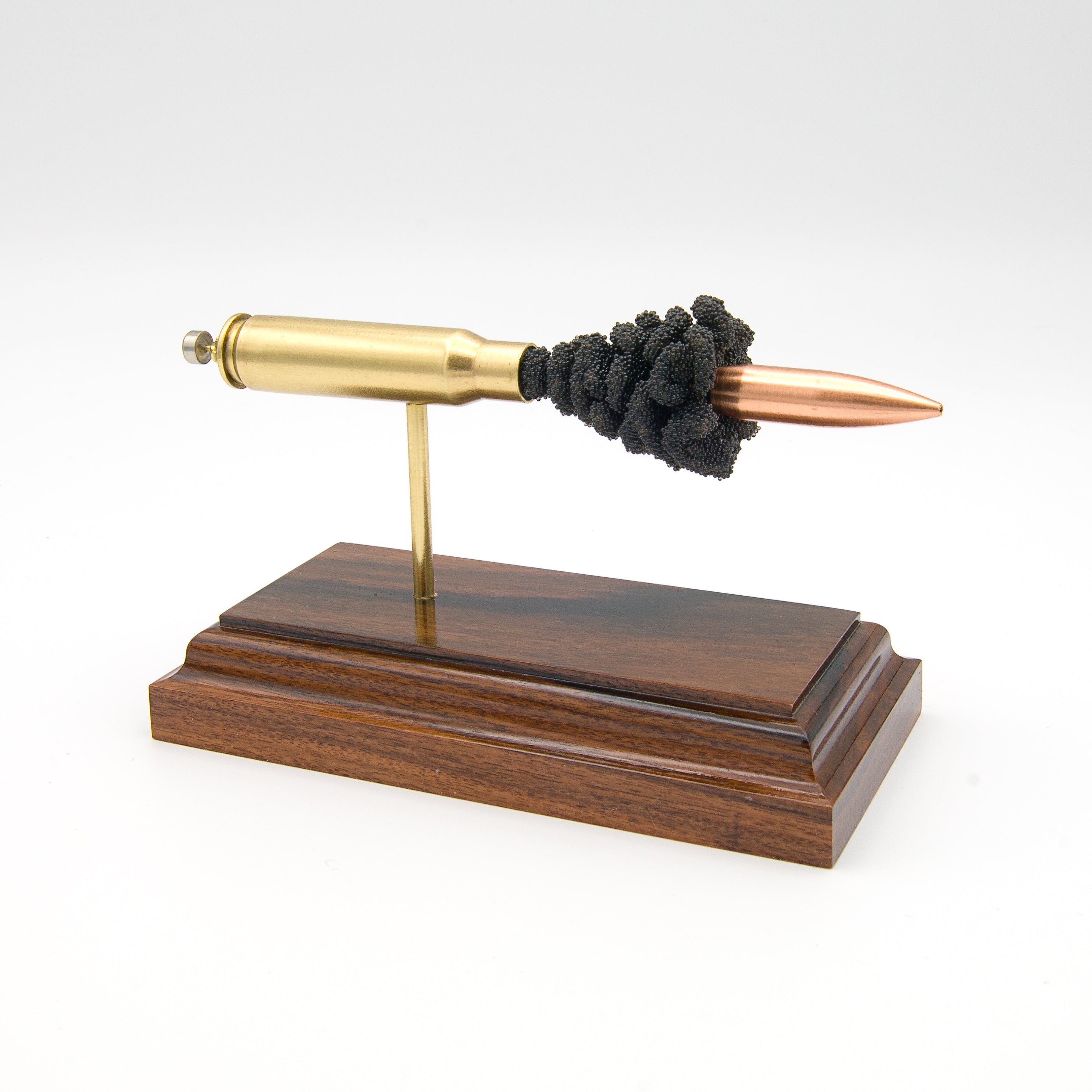 Handmade 7.62x51mm M118 cartridge display aligned on solid wood base