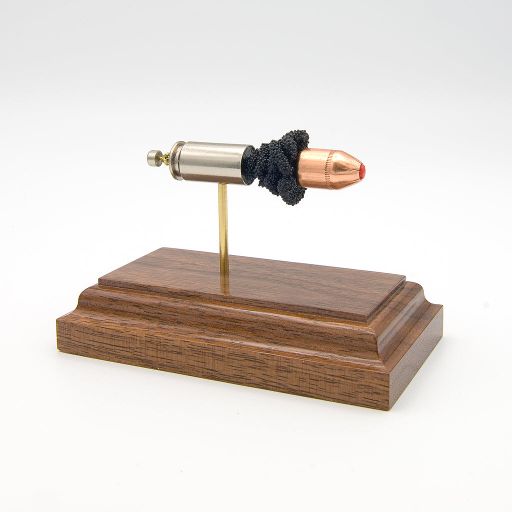 Expanded 40 S&W Hornady Critical Defense cartridge display on hardwood base