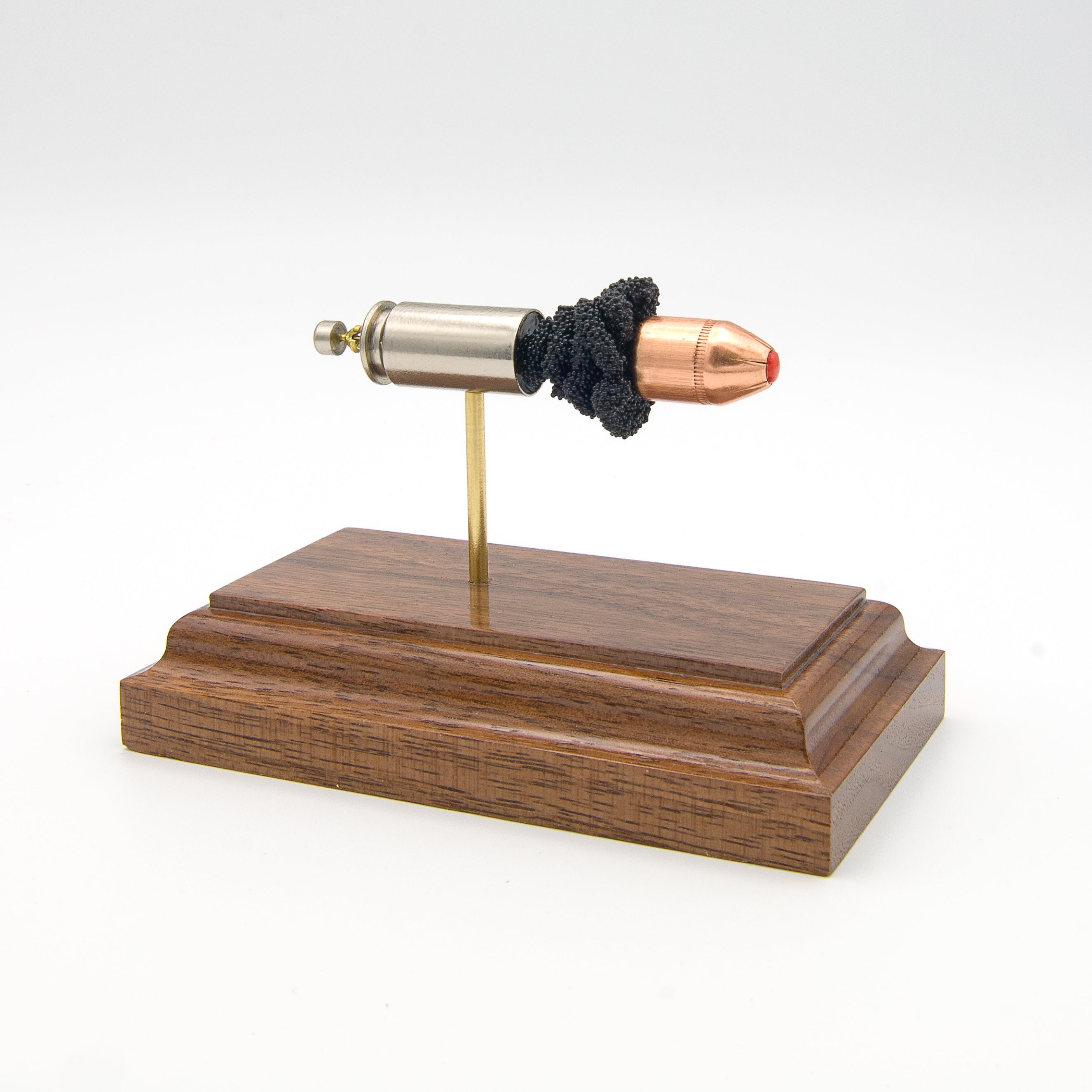 Expanded 40 S&W Hornady Critical Defense cartridge display on hardwood base