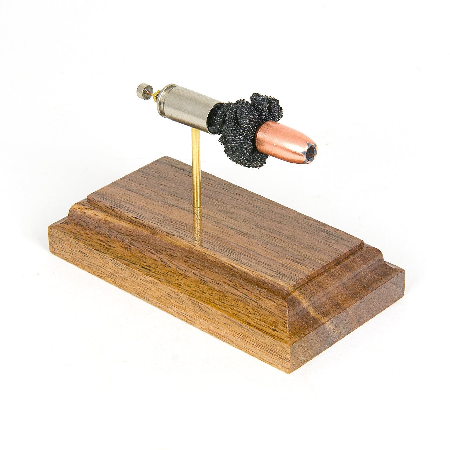 9mm Luger 147gr Speer Gold Dot expanded cartridge display on walnut base