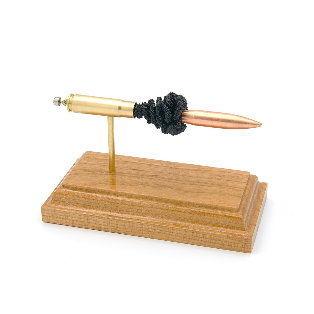 Expanded 300 Blackout Nosler 220gr cartridge display on hardwood base