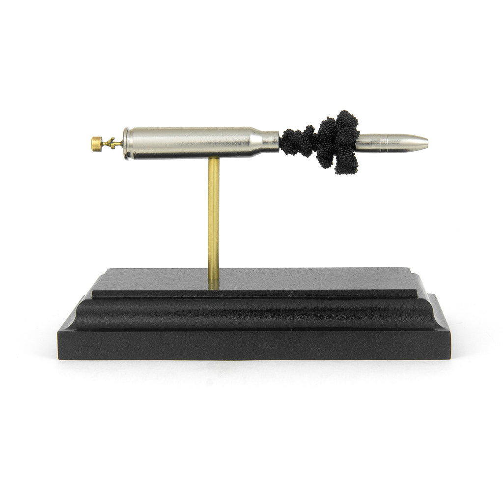 Expanded .223 Rem Liberty Ammunition Civil Defense cartridge display on cherry wood base