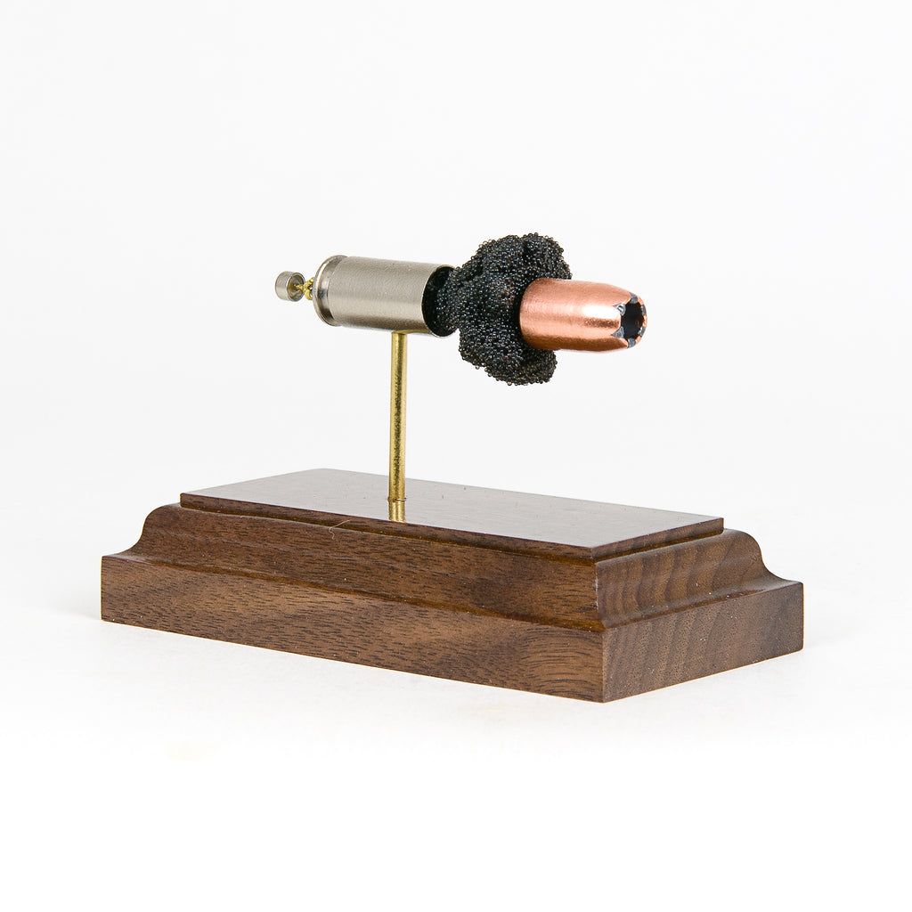 Expanded 40 S&W Speer 180gr Gold Dot cartridge display on hardwood base