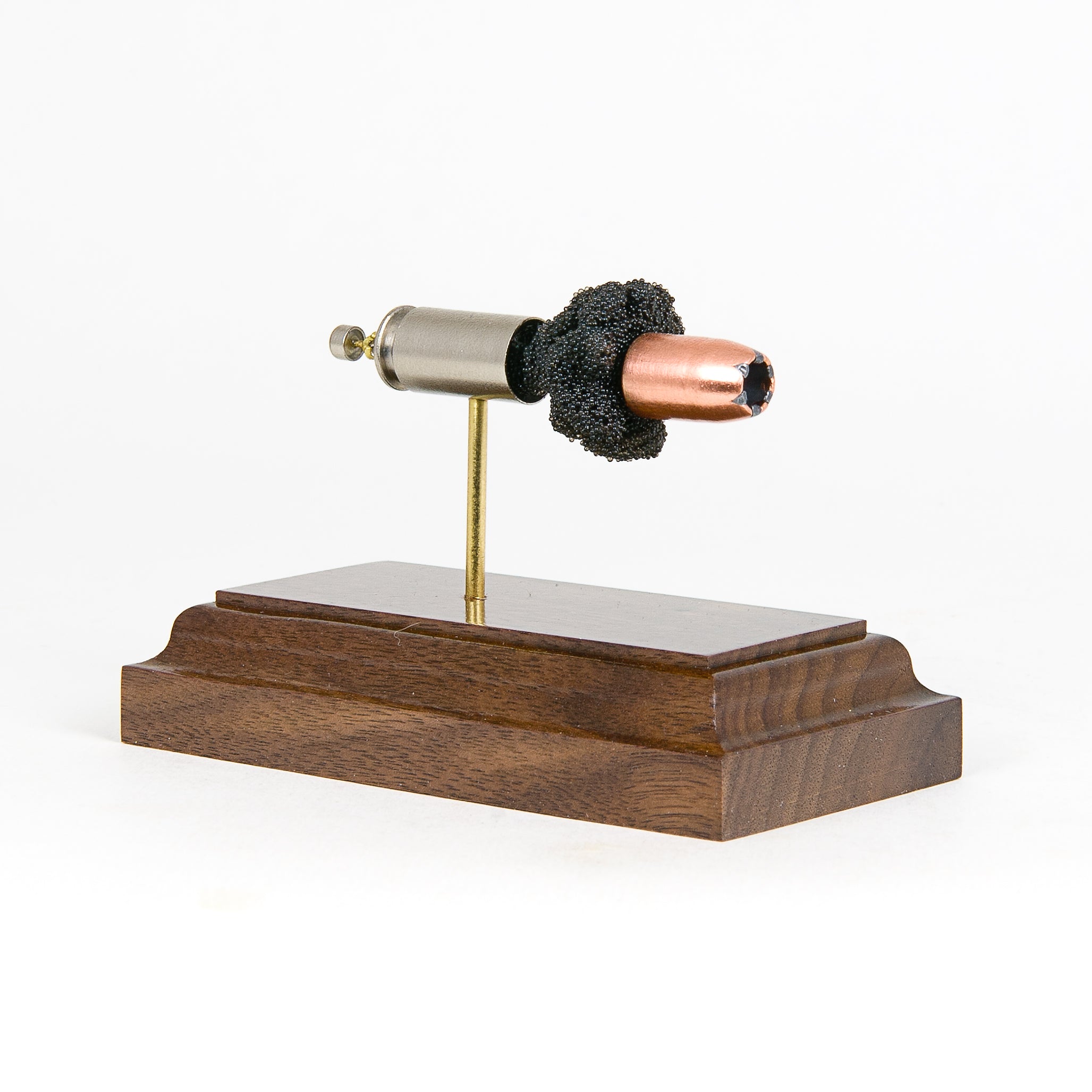 Expanded 40 S&W Speer 180gr Gold Dot cartridge display on hardwood base