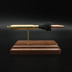 Front view of a .30-06 Springfield Hornady Precision Hunter 178gr ELD-X cartridge anatomy display showing the primer cup, anvil, cartridge case, simulated powder, and projectile on a hardwood base.
