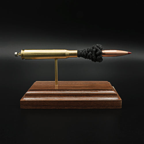 Front view of a .30-06 Springfield Hornady Precision Hunter 178gr ELD-X cartridge anatomy display showing the primer cup, anvil, cartridge case, simulated powder, and projectile on a hardwood base.